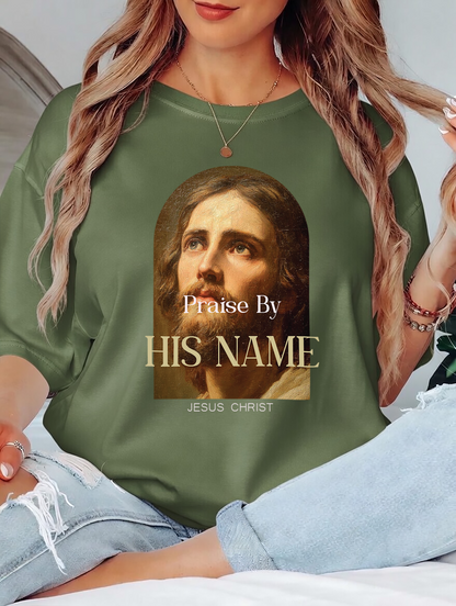 Person wearing a green shirt with a graphic of a religious figure and text.