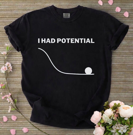 Black t-shirt with 'I Had Potential' text and graphic on a wooden surface with flowers.